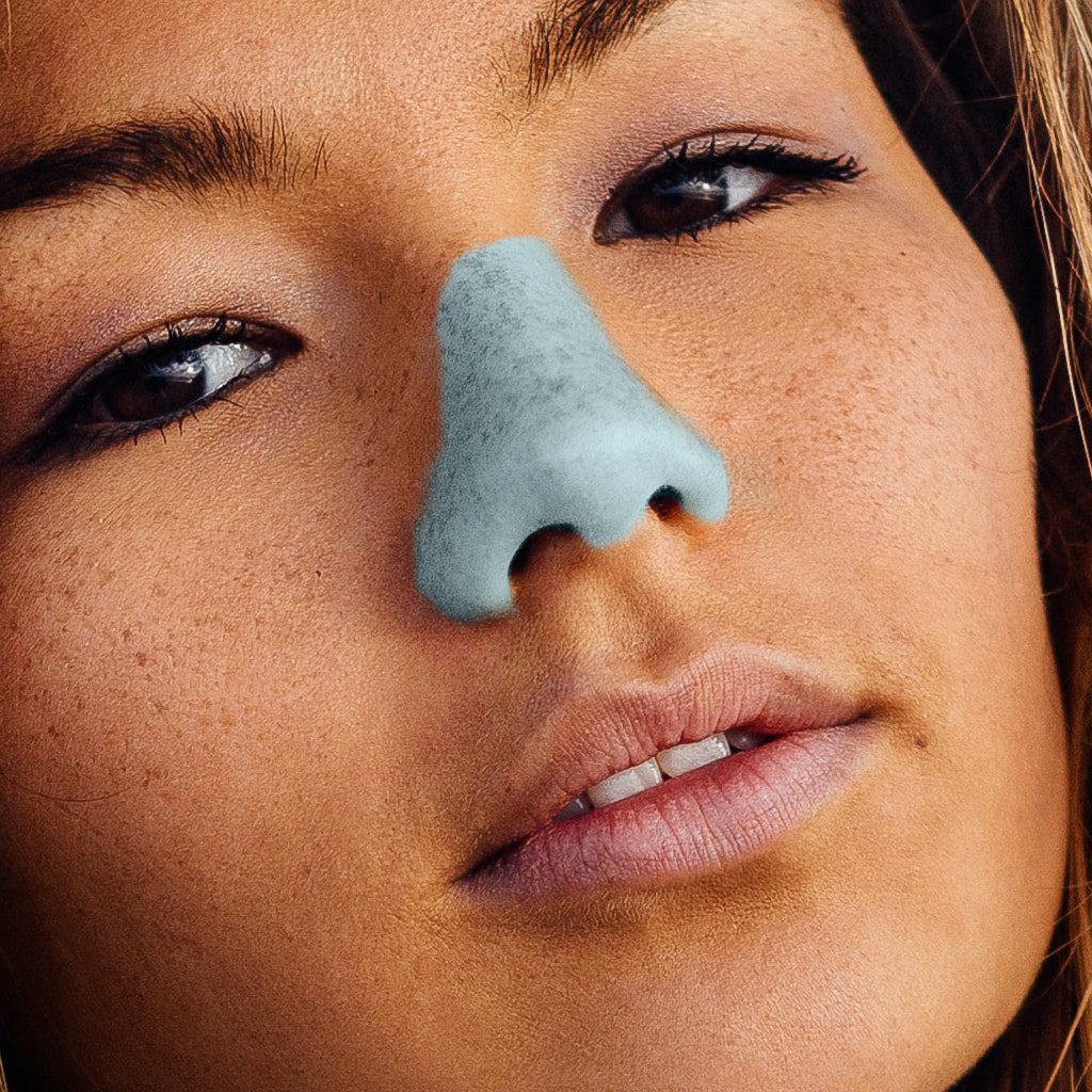 a woman in blue NÖZscreen  on her nose.